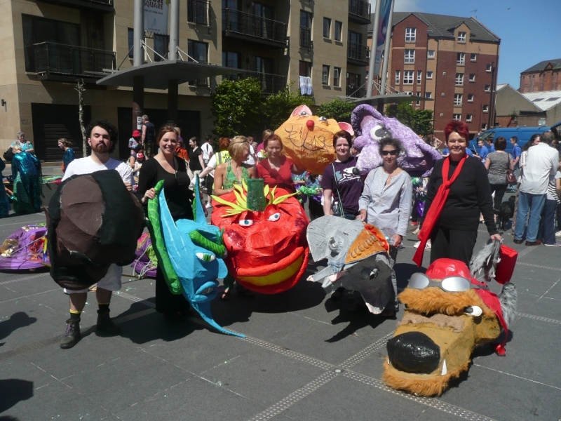 Friendship Club members with 'big heads' preparing for a parade