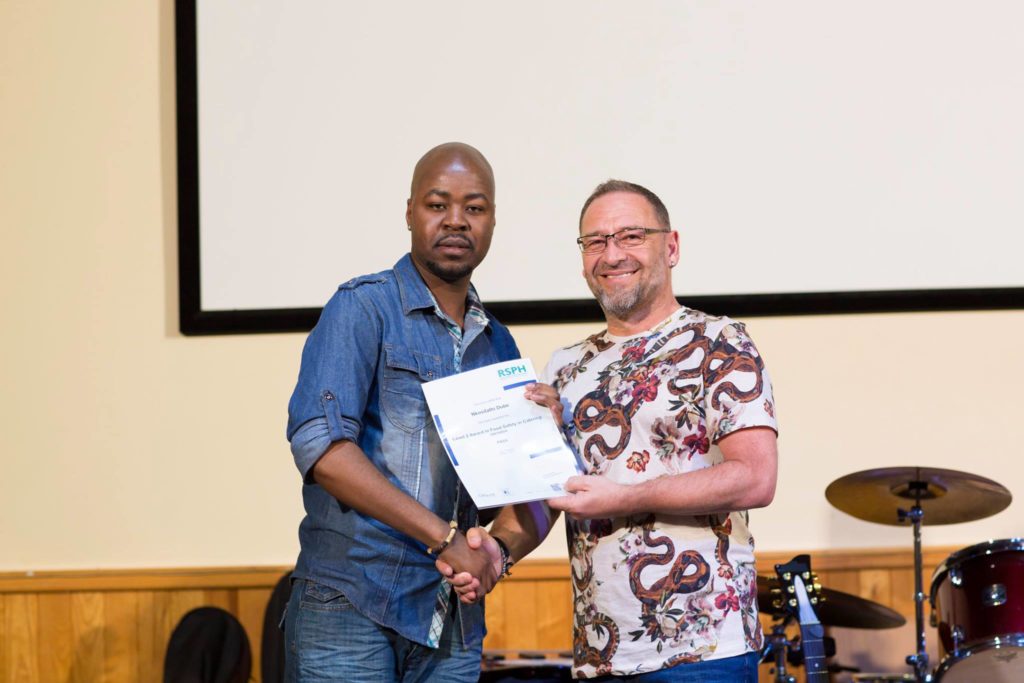 Global Kitchen graduate Ngosi and Urban Community Chef Mark Humphries. Photo: Rashid Kaidanov